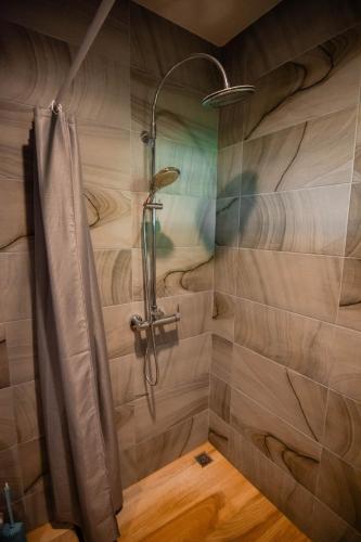 a shower with a shower curtain in a bathroom at Villa Kanya Aonang in Ao Nang 