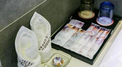 a table with a tray of food and other items at James Joyce Coffetel Chengdu Jianshe Road Dongjiao Jiyi Square in Chengdu