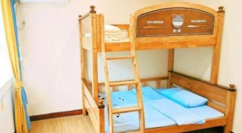 a bunk bed with a ladder in a room at Catic Hotel--Adjacent Buliding in Zhuhai