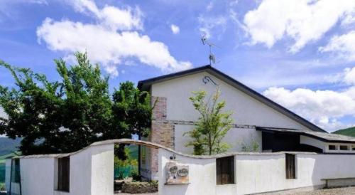 a white building with a cross on top of it at Yufuin Tsukahara Villa ERINA in Yufuin