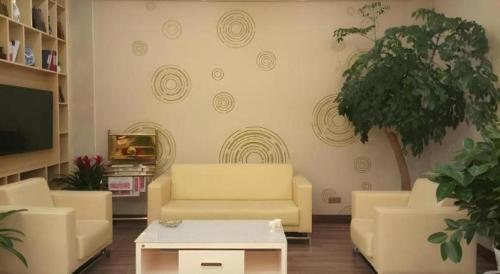 a living room with two couches and a tv at GreenTree Inn Xuancheng Jingxian Wannan First Street Express Hotel in Xuanzhou