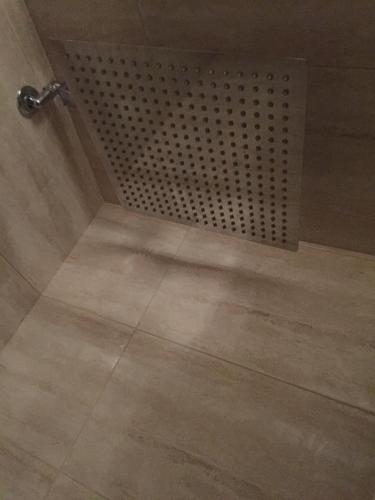a shower in a bathroom with a tile floor at B&B Quintino Sella in Iglesias