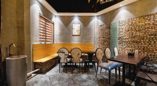 a restaurant with a table and chairs in a room at James Joyce Coffetel Qufu Tourist Center Gulou Street Sankong Scenic Spot in Jining