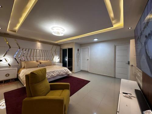 a bedroom with a bed and a couch and a table at Modern villa with pool and all comforts in Mendoza