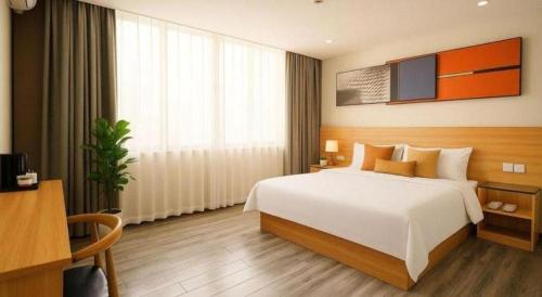 Postel nebo postele na pokoji v ubytování PAI Hotel Zhuhai Doumen Daxin Xinduhui Bus Terminal
