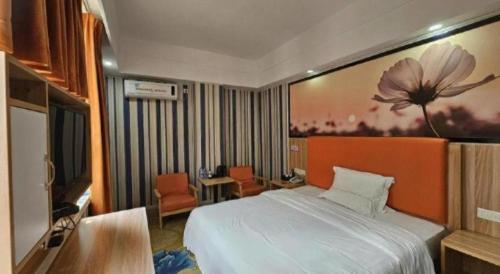 Postel nebo postele na pokoji v ubytování PAI Hotel·Huazhou Bus Terminal