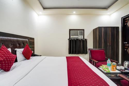 a hotel room with a bed and a chair at Hotel City Lite in New Delhi