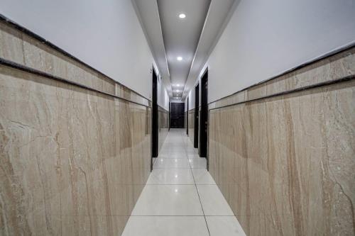 a long hallway with wooden walls and a ceiling at Hotel City Lite in New Delhi