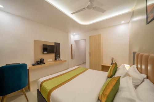 a hotel room with a bed and a tv at Perfectstayz Premium Kaashin near Kashi Ghat in Varanasi