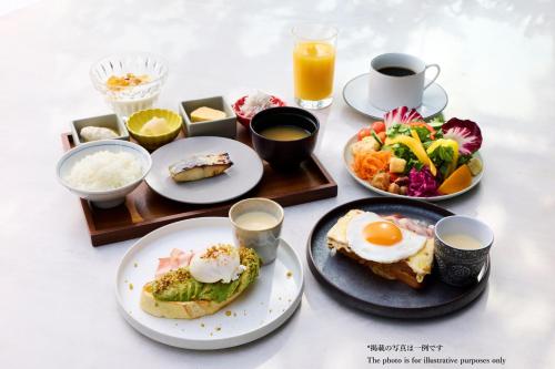 uma mesa com pratos de comidas e bebidas para o café da manhã em The Royal Park Canvas - Ginza 8 em Tóquio