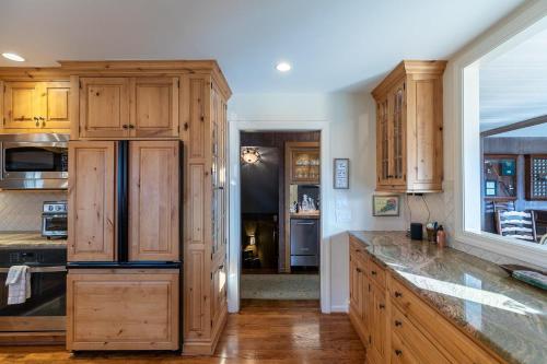 a kitchen with wooden cabinets and a counter top at Hinesight at Hound Ears in Valle Crucis