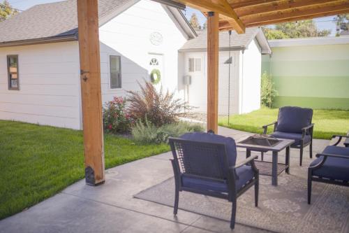 a patio with chairs and a table and a pergola at Charming and Private Birch Cottage in Idaho Falls