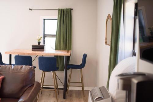 a living room with a table and blue chairs at Charming and Private Birch Cottage in Idaho Falls