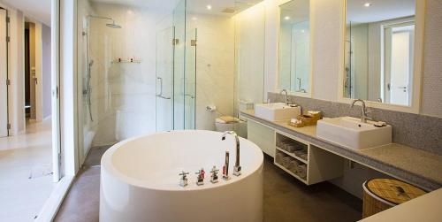 a bathroom with a tub and two sinks and a shower at Heart of Khao Yai Villa in Mu Si