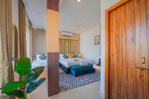 a hotel room with a bed and a room with a door at Perfectstayz Premium Kaashin near Kashi Ghat in Varanasi