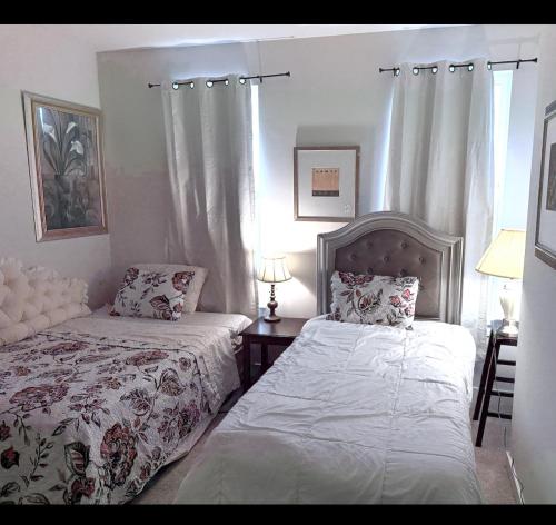 a bedroom with two beds and a window at Red sound retreat in Laurel
