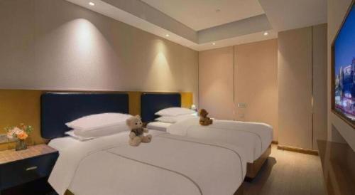 Ένα ή περισσότερα κρεβάτια σε δωμάτιο στο The Hotel V Nanjing Confucius Temple