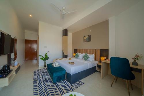 a hotel room with a bed and a table and chairs at Perfectstayz Premium Kaashin near Kashi Ghat in Varanasi