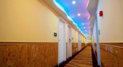 an empty hallway with a brightly lit ceiling at Ease Hotel Shanghai Chuanhuan Nan Road Chuansha Metro Station in Shanghai