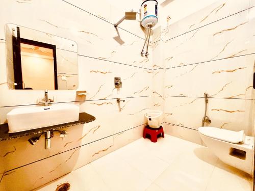 a bathroom with a sink and a toilet at Hotel LA Meridian, A Luxury Hotel & Resort, Haridwar in Haridwār