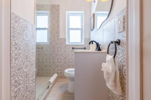 a bathroom with a toilet and a sink and a shower at Casa Agave Miami in Miami