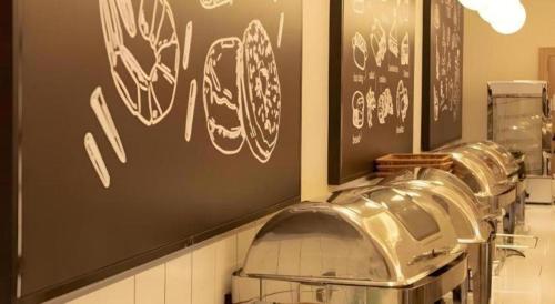 a barber shop with graffiti on the wall at Green Tree Inn Fuyang Funan County Tianzhu Square in Funan