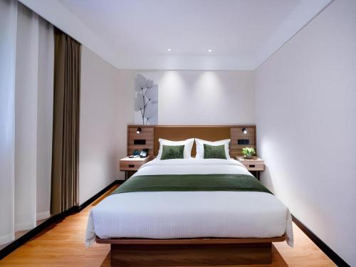 Ένα ή περισσότερα κρεβάτια σε δωμάτιο στο GreenTree Inn Express Hebei Tangshan Guyan District Xinguang Road