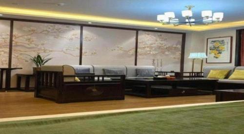 a living room with a couch and a table at GreenTree Inn Express Datong High-Speed Railway Station Wanda Plaza Fangte in Datong