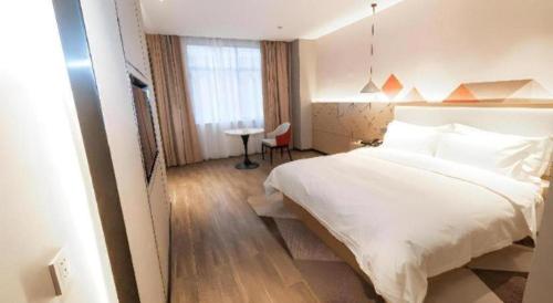 Ένα ή περισσότερα κρεβάτια σε δωμάτιο στο Borrman Hotel Yongzhou High Speed Railway Station