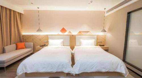 Ένα ή περισσότερα κρεβάτια σε δωμάτιο στο Borrman Hotel Yongzhou High Speed Railway Station
