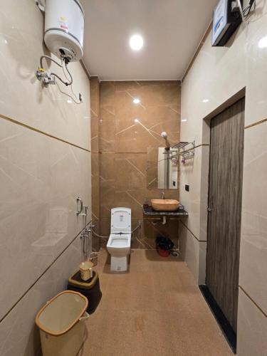a bathroom with a toilet and a sink at prabh aasra in Ayodhya