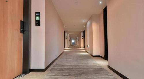 a hallway of an office building with a long corridor at Green Tree Inn Express Zhejiang Zhoushan Xincheng Zheda in Zhoushan