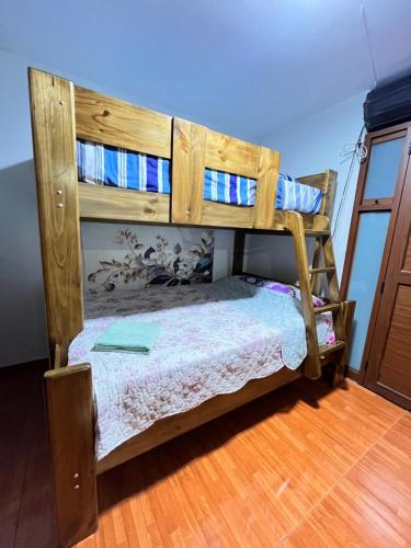 a bunk bed in a room with a wooden floor at Hospedaje el Trujillanito in Víctor Larco Herrera