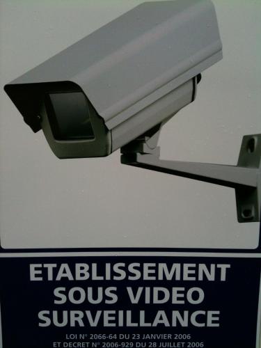 a security camera with a sign in front of it at Premiere Classe Carcassonne in Carcassonne