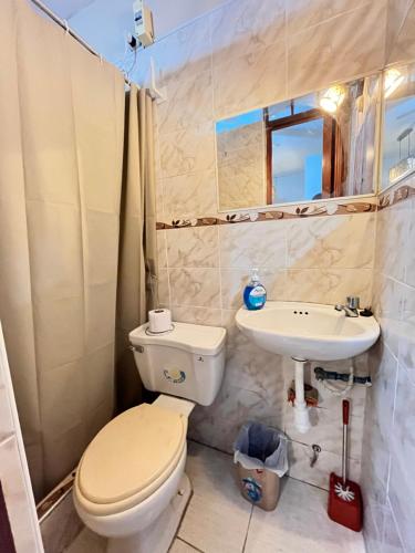 a bathroom with a toilet and a sink at Hospedaje el Trujillanito in Víctor Larco Herrera