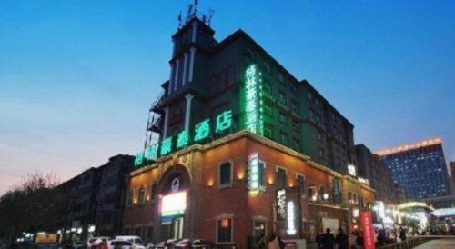 a building with green lights on the top of it at GreenTree Inn Luoyang Henan University of Science and Technology in Luoyang