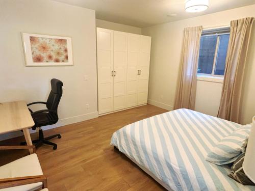a bedroom with a bed and a desk and a chair at 5 mins walk to beach! Lovely, spacious bedroom near Beach, Stanley Park, Cypress Mountain, Downtown Vancouver, Grouse Mountain in West Vancouver
