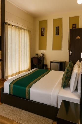 a bedroom with a large bed in a room at Hotel Citrine, Vrindavan - A Four Star Luxury Retreat # By Nandan Group # in Vrindāvan