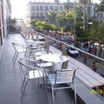 a patio with tables and chairs on a balcony at Hotel Inglaterra in Tampico