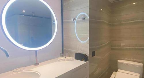 a bathroom with a shower and a sink and a mirror at OASIS AVENUE-A GDH HOTEL in Hong Kong