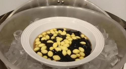 a white bowl filled with balls in a bucket at Sans Hotel in Ratchaburi