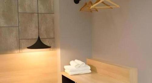 a pile of towels sitting on a counter in a room at Sans Hotel in Ratchaburi