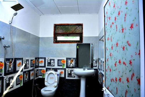 a bathroom with a toilet and a sink at Angel Haven Villa in Mirissa