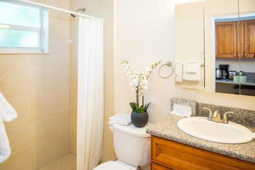 a bathroom with a toilet and a sink and a shower at Shore Haven Resort Inn in Fort Lauderdale