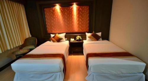 Кровать или кровати в номере Piyaporn Pavilion Hotel