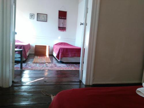 a room with a bedroom with a bed and a door at Odyssey Guest House in Bergama