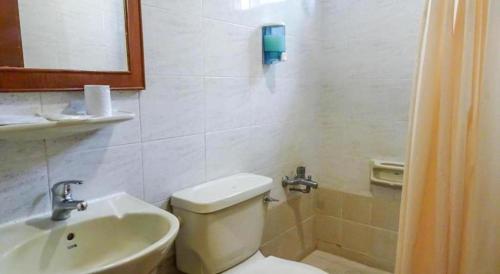 a bathroom with a toilet and a sink at Four Chain View Hotel in Singapore