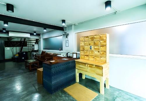 an office with a desk and a table in a room at XX GO INN Khaosan โก อินน์ ตรอกข้าวสาร in Bang Bua Thong Railway Station
