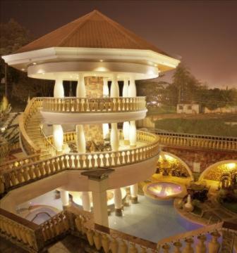 a large white building with a large pool in front of it at Casablanca Hotel Condominium Resort in Olongapo