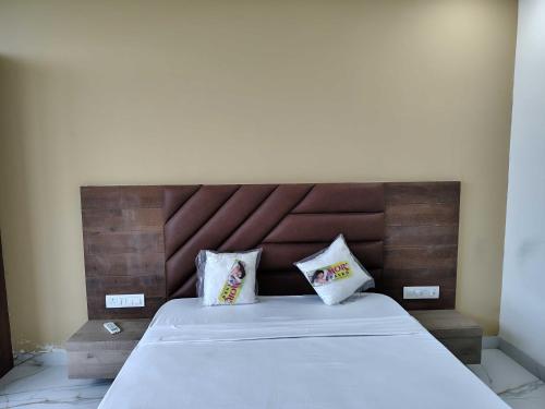 a bedroom with a large bed with two pillows at Hotel O Eternity Stays in Rao
